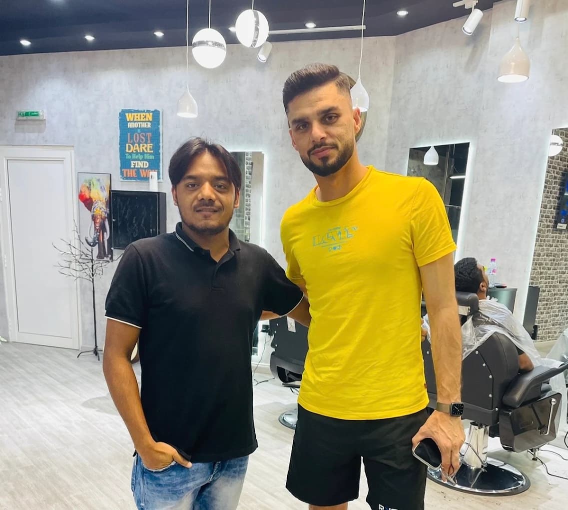 Afghanistan cricketer Azmatullah Zazai with the barber at Desi Barbers after a cut