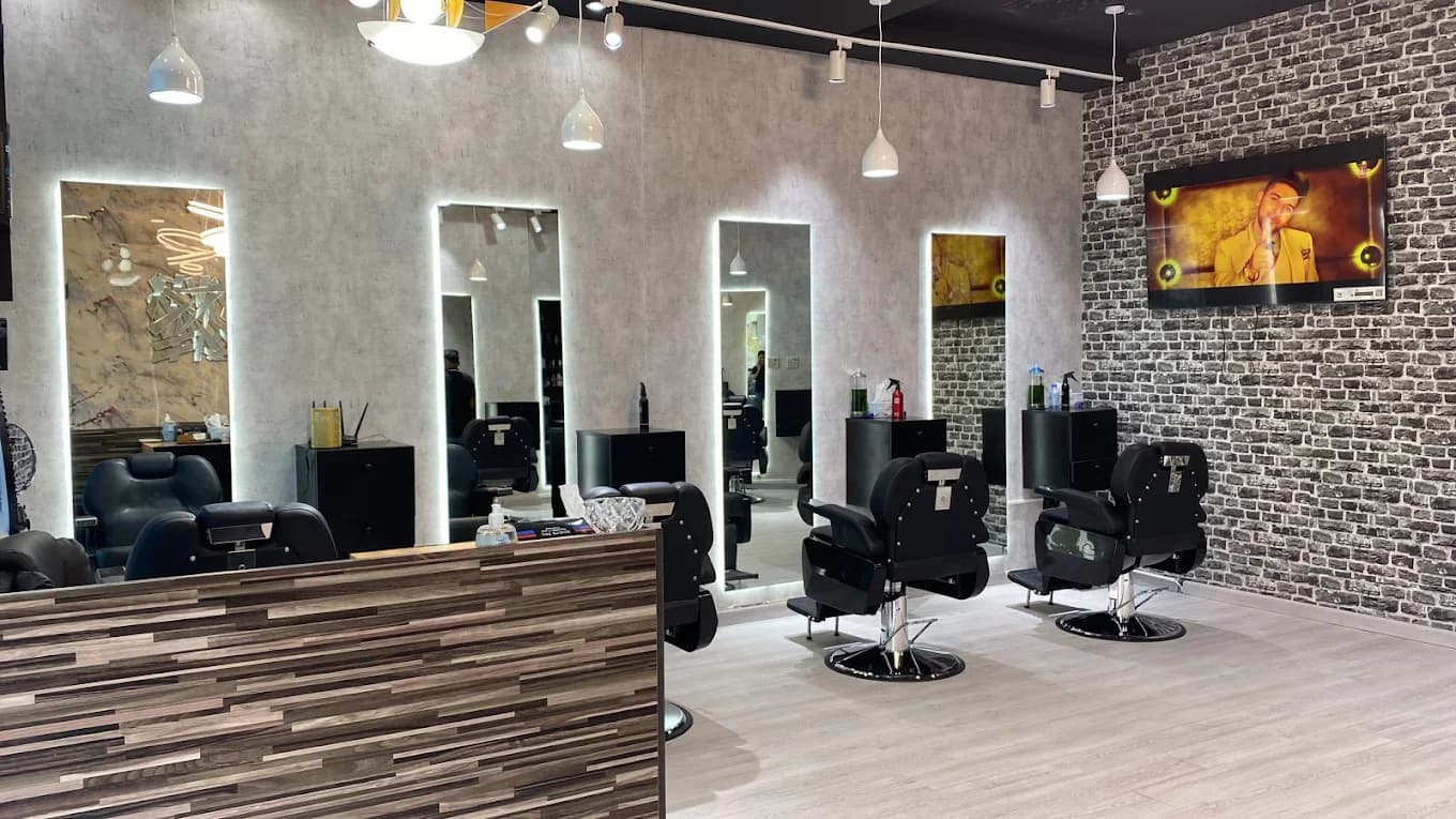 The floor at Desi Barbers — chairs, mirrors and warm light